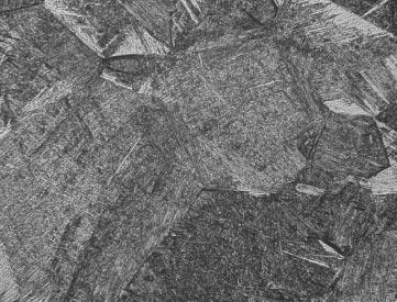 In the micrograph of the quenched specimen (c), fine needle-like traces in each grain were observed. XRD profile (d) indicated that the quenched specimen consisted only of the 00 martensite structure.