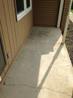 (Exterior continued) Comment 14: Front concrete porch sloped toward structure. Possible hidden damage at front wall of home.