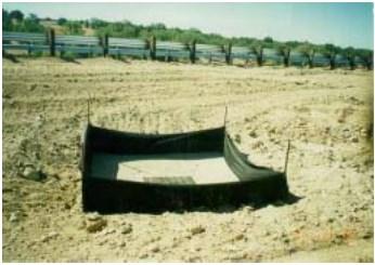 Temporary geotextile storm drain inserts attach underneath storm drain grates to capture