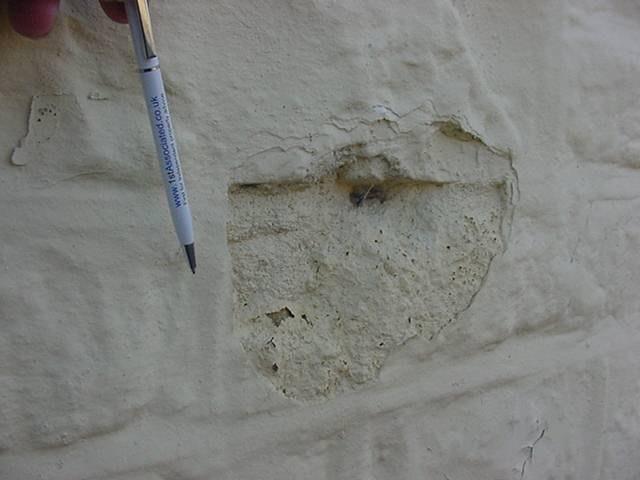 Painted stonework Re-pointed in cement mortar, some stones can be seen