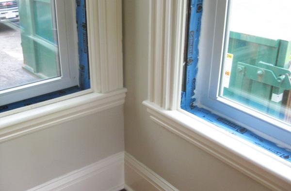 Positive drainage of the window sill pan flashing is established by cutting the foam at the bottom of the window