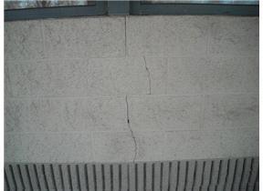 condition. One hairline crack visible on the front of the building, no differential separation. Recommend monitoring for further movement and repair as needed.