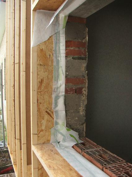 Timber frame construction fixed to the existing wall.