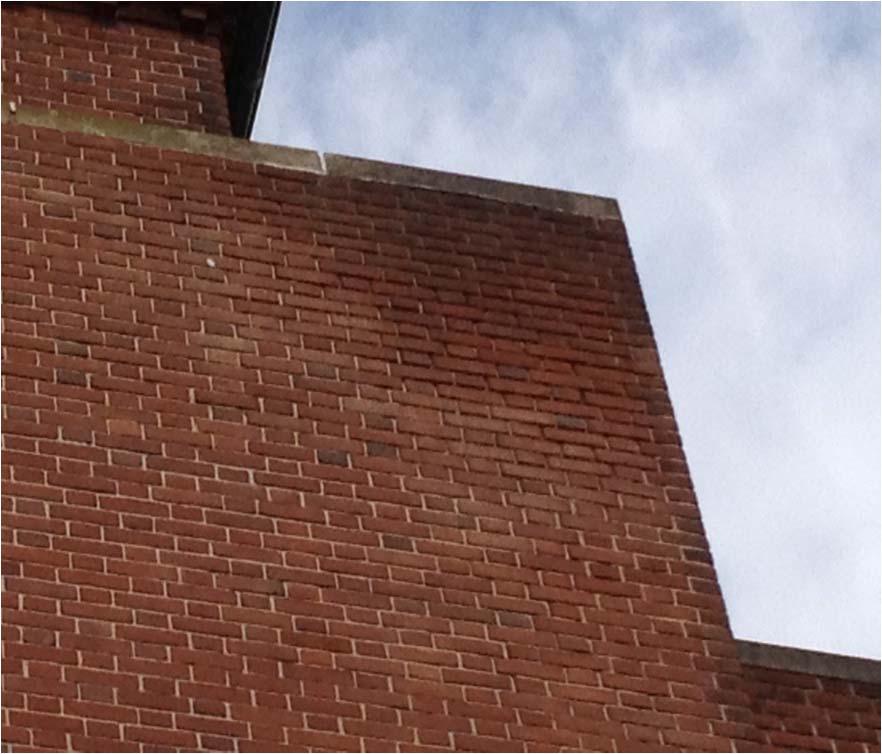 Along with some of the parapet walls Exterior corner at west elevation of high roof with wet brick and what