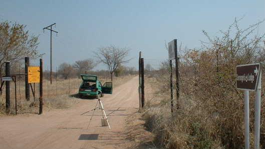 Location 2 At the gate of the farm Vlakfontein at the edge of the dirt road as shown in the following photographs. GPS Coordinates S 23 36.725, E 27 18.894, altitude 879 ± 4.8m.