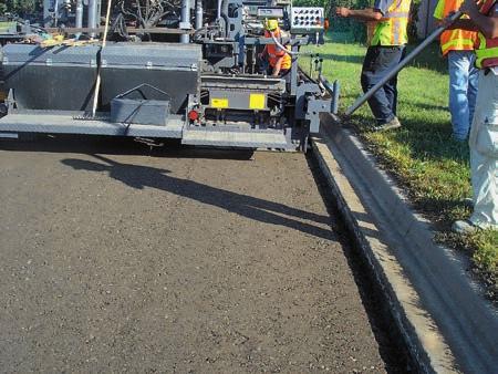 working speed, adding metered amounts of compaction moisture to suit varying in-situ conditions, water taken from on-board tank, and paving the recycled/ stabilized material to the design slope of 2