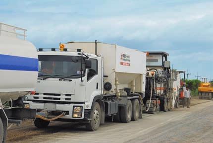 06 07 2200 CR Road rehabilitation with cement, Thailand Cold recycling with cement Wirtgen cold recycling 2200 CR pushes Streumaster cement spreader SW 16 MC.