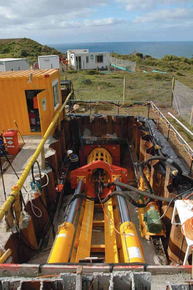 the completed tunnel from a pipelay barge moored offshore using a winch located onshore.