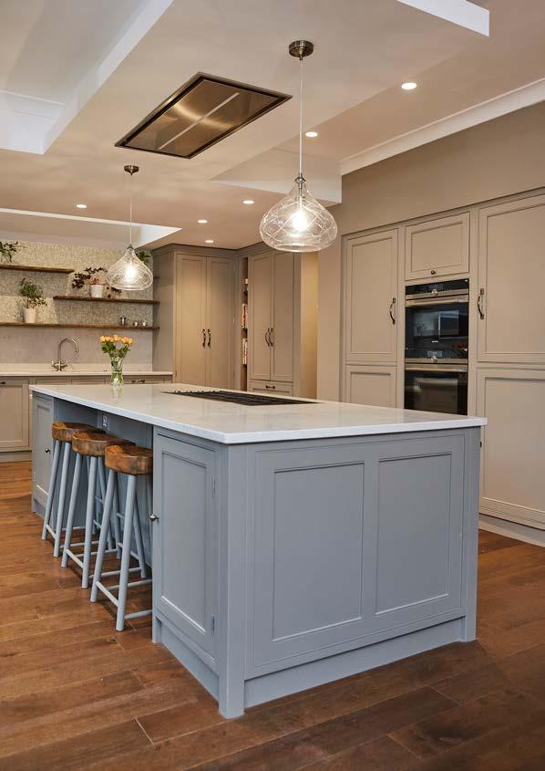 Shaker-style cabinets are painted in neutral tones to introduce warmth