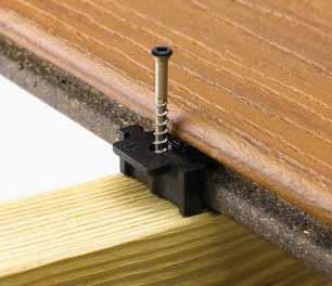 When using grooved-edge boards, the hidden deck fastening system installs between the deck boards, fastening them to the joists with no visible deck screw heads on the walking surface.