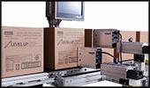 Apply labels to one, two or three sides of box or pallet. Works with irregular pallets and tolerances in material handling. Laser type sensor locates the position of the area to be labeled.