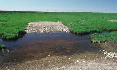 This can cause flooding and erosion. Erosion of the stream bed may occur with high flows.
