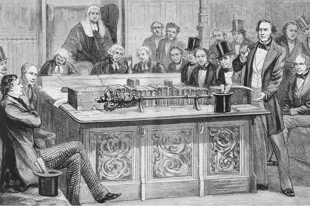 A House of Commons Debate. William Ewart Gladstone, standing on the right, is attacking Benjamin Disraeli, who sits with legs crossed and arms folded.
