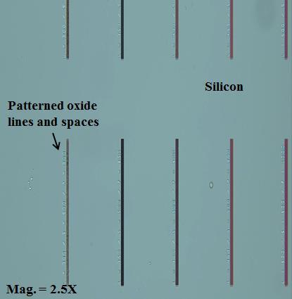The aluminum RIE did not remove the silicon from the surface of the oxide, and it carried on through the oxide etch which resulted in nonuniform etching with spiking effect.