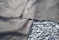 PLACE GEOTEXTILE - CONT. Adjacent panels of material should be overlapped by 12 or more, as shown on the plans.