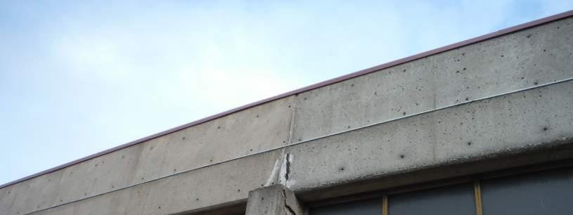 Spalling of concrete due to rebar corrosion was also observed above the entrance on the north side of the building (Photo 1).