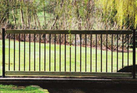 The round-paled fence is matched with a timber rail capping which is made from planed timber to reduce the risk of splintering.