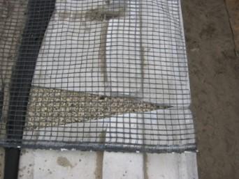 When placing backfill over a layer of geogrid, start just behind the drainage aggregate and fill toward the tail of the geogrid.