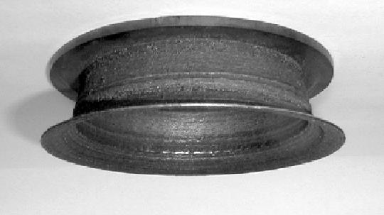 Figure 7: Structure built up from a Co-base-alloy powder by the blown powder process: Prototyped sample with cylindrical symmetry (left).