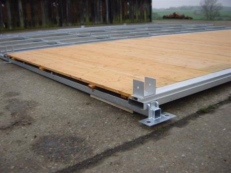 5m in width and is laid onto a mesh of steel beams, with aluminium track joists. The underside of each panel has cross bars fitted for stability. Both 5m and 3m bay lengths can be accommodated.