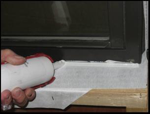 Apply a new piece of sheathing tape over the entire diagonal cut made in the WRB.
