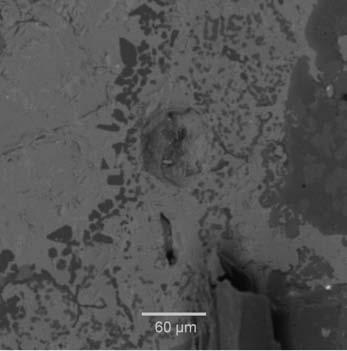 the magnesia-chrome brick reacted at 1750 C Figure 12 Backscattered electron image of the matte-refractory interface at 1600 C (dark grey phase in the light grey matte is Mg-rich silicate crystals)