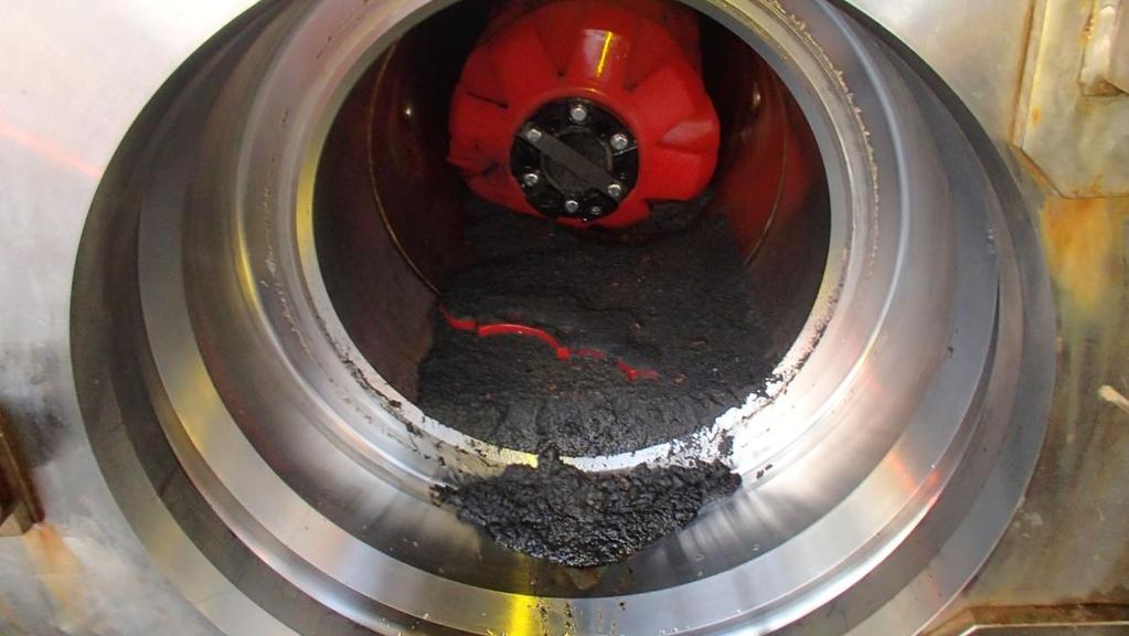 Figure 4: De-sanding pig and debris in receiver during operational cleaning Although the exact quantities of debris returned by each pig are unknown due to the flushing and purging operations, the