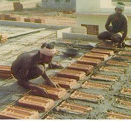 2. The shuttering for slab is erected as for a conventional RCC slab. Fig. 9.3: Laying of Mangalore tiles for filler slabs. 3.