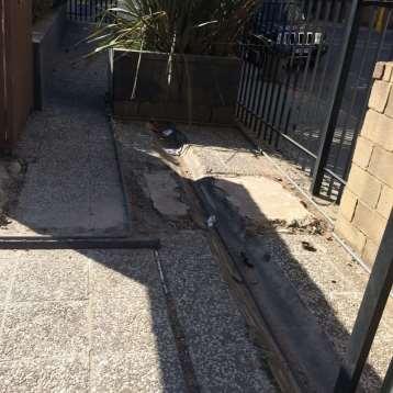 Figure 29: Sliding gate track appears to be a retrofit security installation and acts as a water