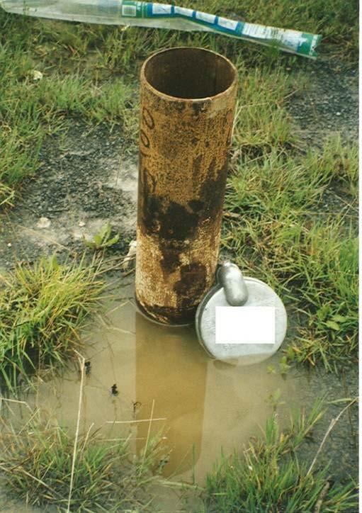 consumption. The hole is located close to the ground surface. The ground surface is not properly sloped and can allow for ponding of surface water adjacent to the well.