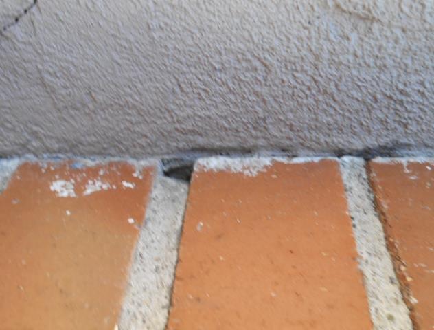 Also visible attempts to caulk under the flashing in many areas above the lower window and