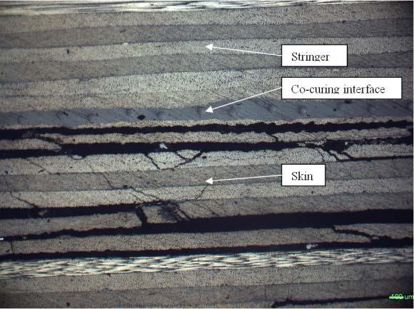 Figure 5). Damage morphologies of skin by the both ends of stringer are slightly different. There are some longitudinal cracks in the front-end of stringer, which connect with the interlaminar cracks.