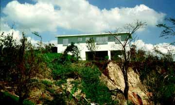 FIGURE 4-6 Residential home constructed of reinforced concrete and masonry with a reinforced concrete roof deck in the mountains outside Adjuntas. 4.2 Masonry The BPAT investigated a limited number of residential and nonresidential masonry buildings.