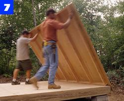 Carefully raise the end wall into position. Note how the plywood siding hangs down to cover the floor framing.