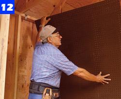 Install perforated hardboard to the partition wall in the tool-storage area. Fasten it with 1-1/4- in. screws.