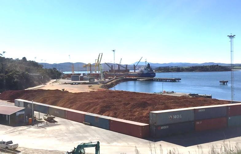 (in distance) being loaded with 35,000 tonnes of bauxite from the