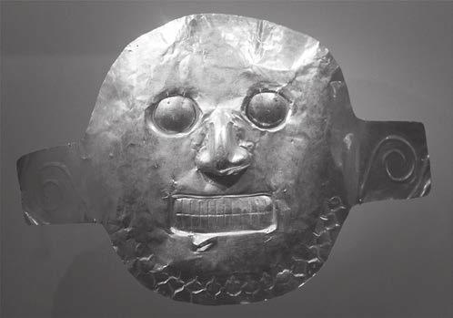 (b) The photograph shows a mask discovered in Colombia. It is made from a gold and copper alloy.