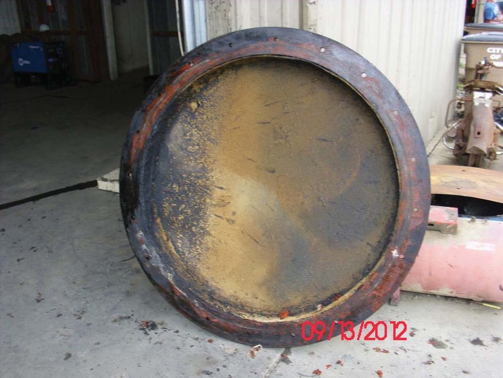 M. Description: Homemade tire pyrolysis unit with front cover removed.