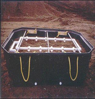 Figure 5. An aboveground view of modular peat filters showing the distribution network, peat over the network, and the cover being placed over the module.