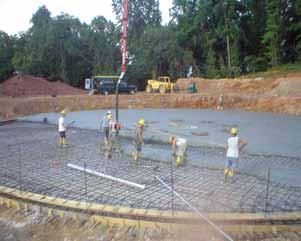 Concrete is placed in a continuous monolithic pour and steel trowel finished. The forms are removed and the base is covered or sprinkled with water to achieve proper curing.