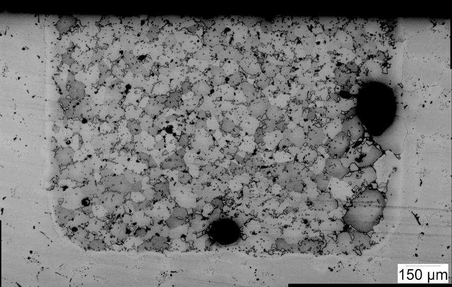 isothermal solidification zone/athermal solidification zone interface. The crack coalesced with the large void and followed along the grain boundaries.