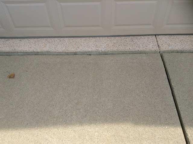 The automatic safety reverse on the garage door was tested and found to be functional. The concrete garage floor was in good condition.