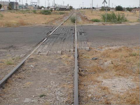 The rail is severely worn in many locations and the underlying defective tie conditions allow significant vertical deflection of the track as well as gauge deviations when under load.