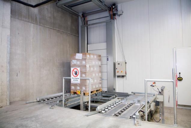 6 Pallet at receiving station in front of pallet entry door Stacker crane in deep-freeze warehouse These systems also generate electricity from lowering their lift carriages, using their motors as a