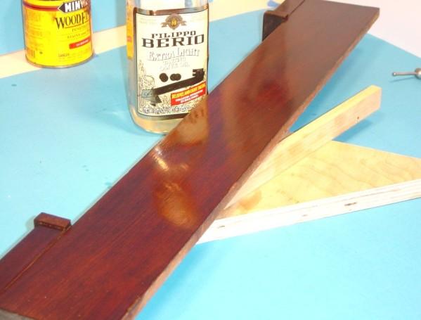 The combination of olive oil and shellac on the rubber will smooth the finish and ensure that any