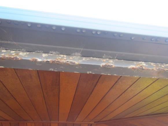 c) The metal beams have substantial rust in areas