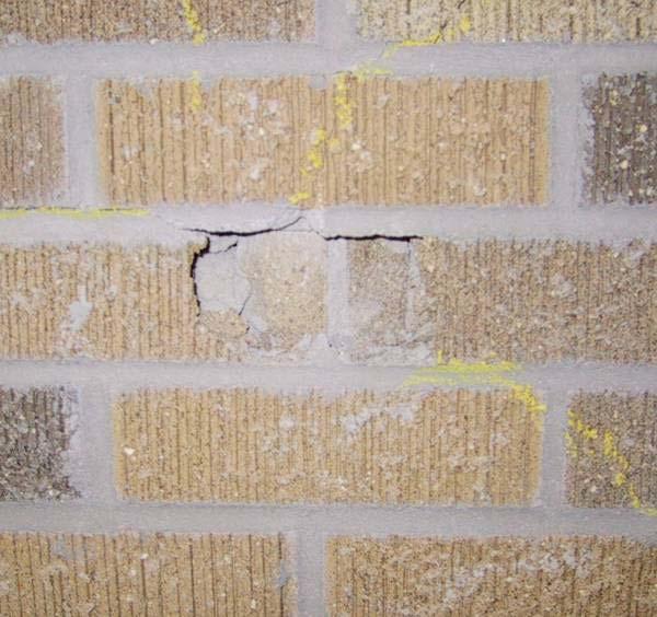 resistant barrier and no damage to the sheathing. A shear crack was visible through the thickness of the brick below the point of impact.