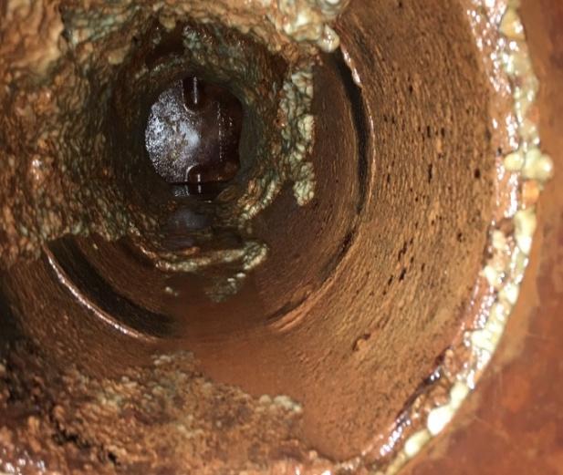 The following photos are from piping going into a plate and frame heat exchanger on an open air washer system. Years of deposits were removed after three months exposure to moss treated water.