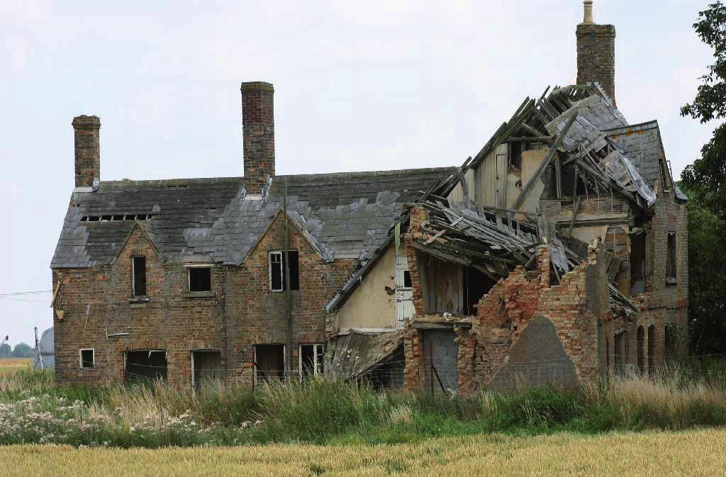 14 7 The photograph shows a building that has suffered structural damage.