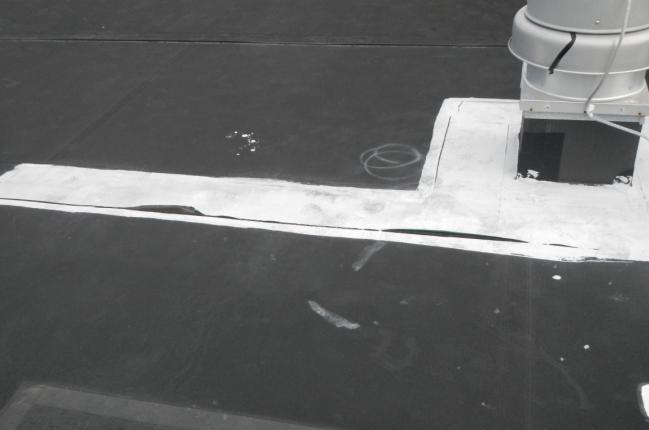 Holes, splits, and failing seams in the EPDM single ply membrane were observed during REI s site visit. All of the seams are curling and the adhesive bond between them is deteriorating.